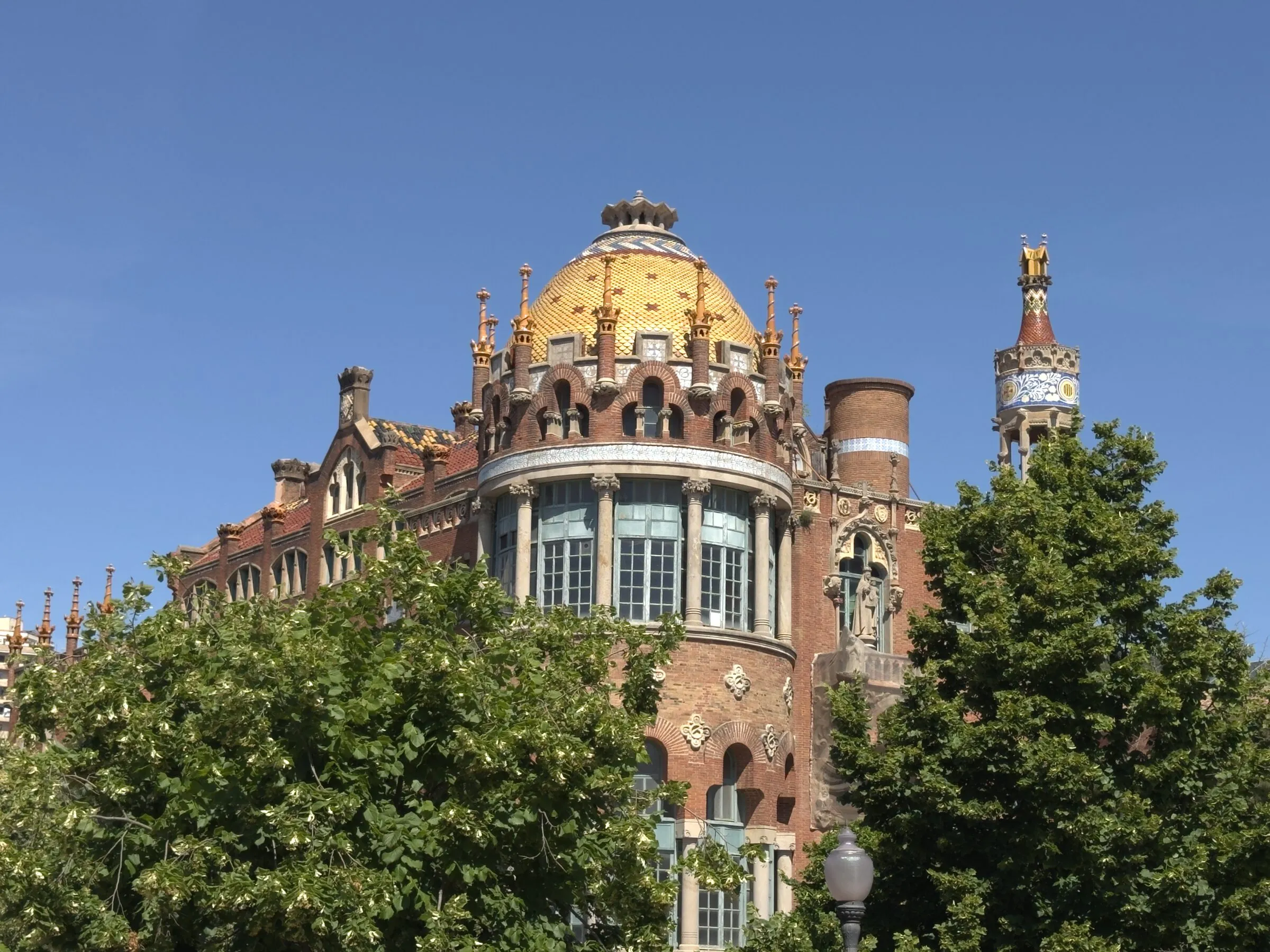 A mosaic tower and gold dome at the Hospital de Sant Pau, Barcelona