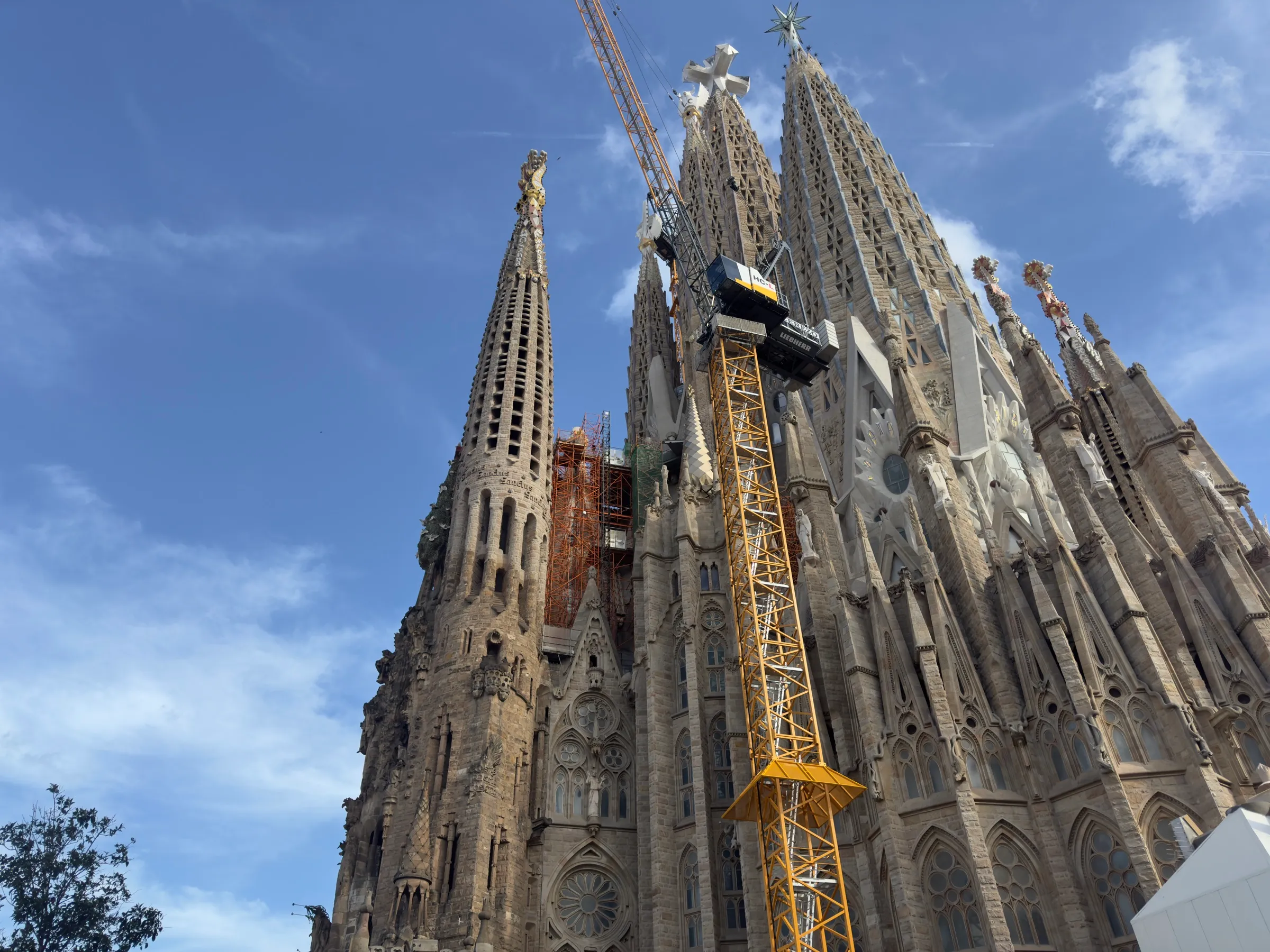 The spires of the Sagrada Família rising into a blue sky.